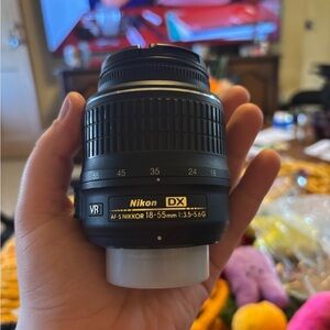 Nikon Black Camera Lens AF-S DX NIKKOR 18-55mm and the second one is a Af-P